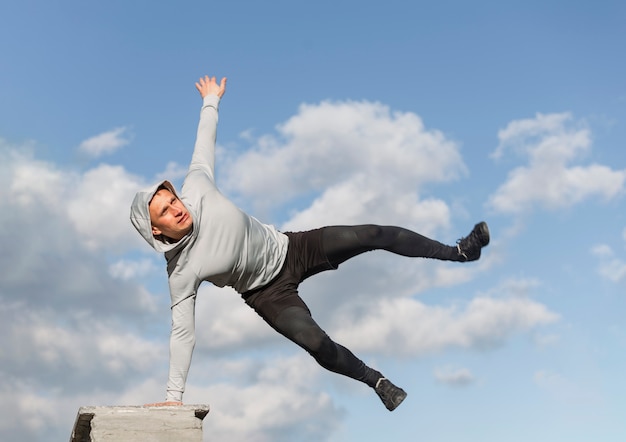 Front view handsome man making parkour