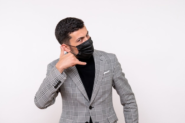 Front view handsome man in suit making call me phone gesture standing on white isolated background