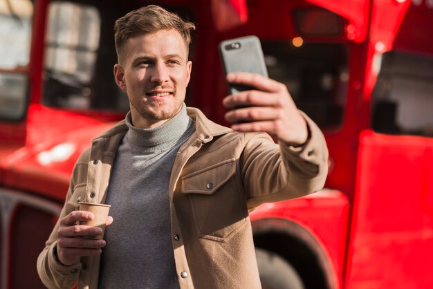 Front view of handsome man taking a selfie