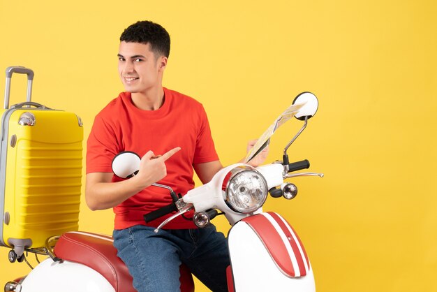 Front view handsome young man on moped holding map