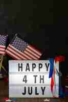 Free photo front view happy 4th july sign with flags and copy-space
