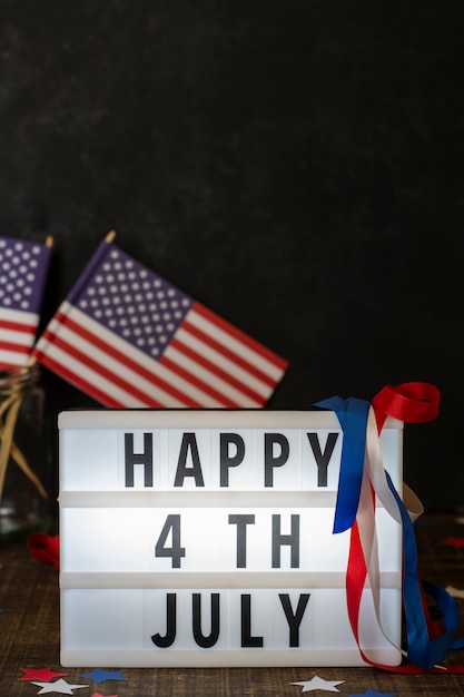 Front view happy 4th july sign with flags and copy-space