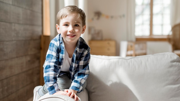 Free photo front view happy boy at home playing