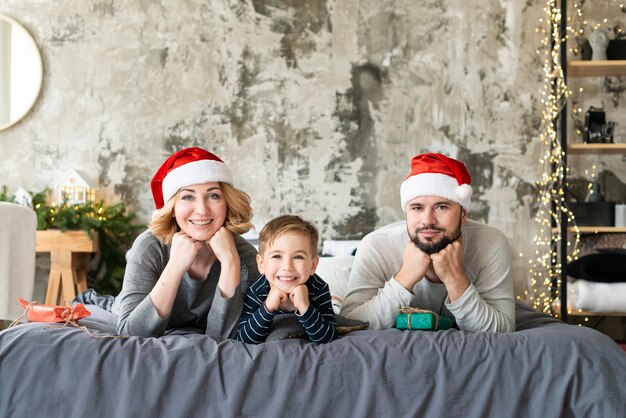 Front view happy boy and parents being together on christmas day