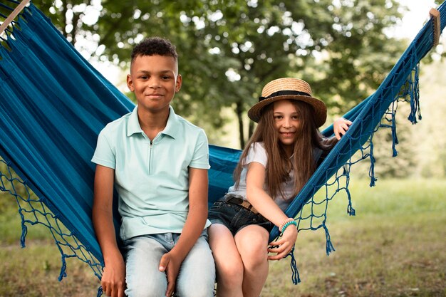 Front view of happy children in hammock