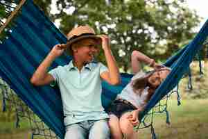 Free photo front view of happy children in hammock