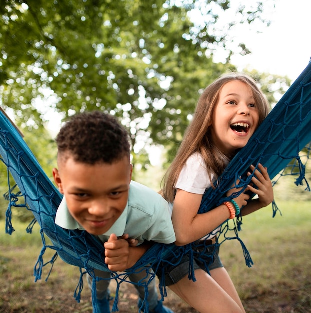 Front view of happy children in hammock