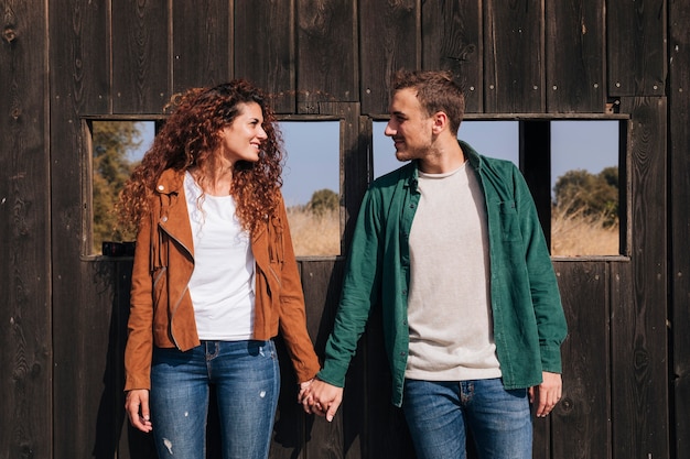 Front view happy couple holding hands