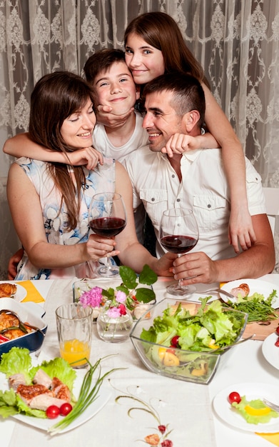 Front view of happy family at dinner table