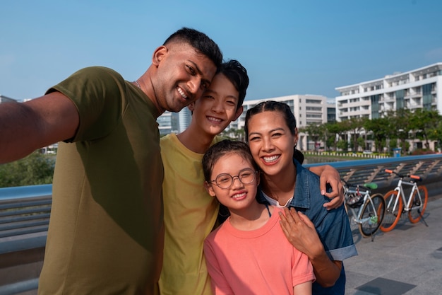 Free photo front view happy family outdoors