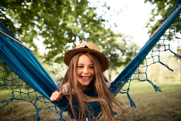 Front view of happy girl in hammock