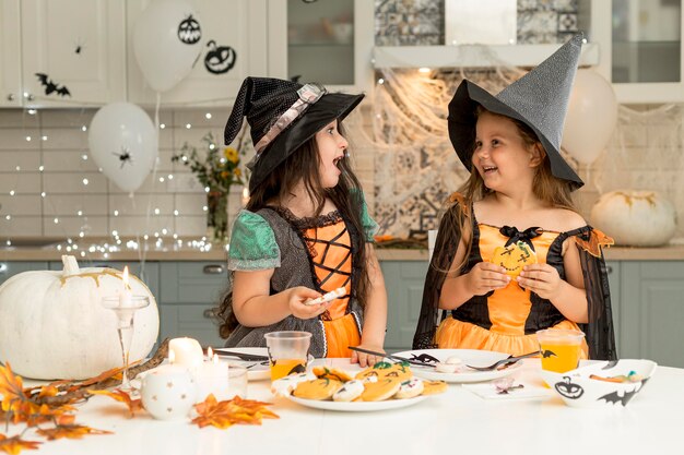 Front view of happy girls in witch costume