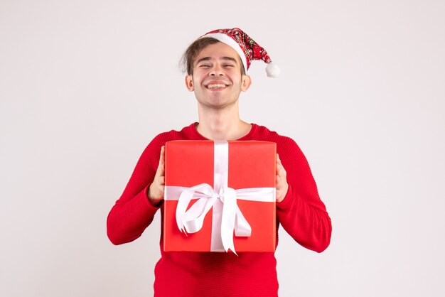 Front view happy handsome man with santa hat standing on white 