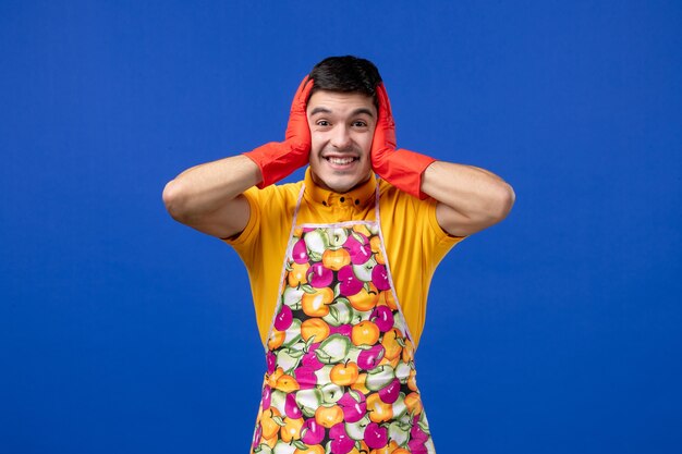 Front view happy housekeeper man holding his head 