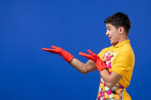 Front view happy housekeeper man reaching out his hands 