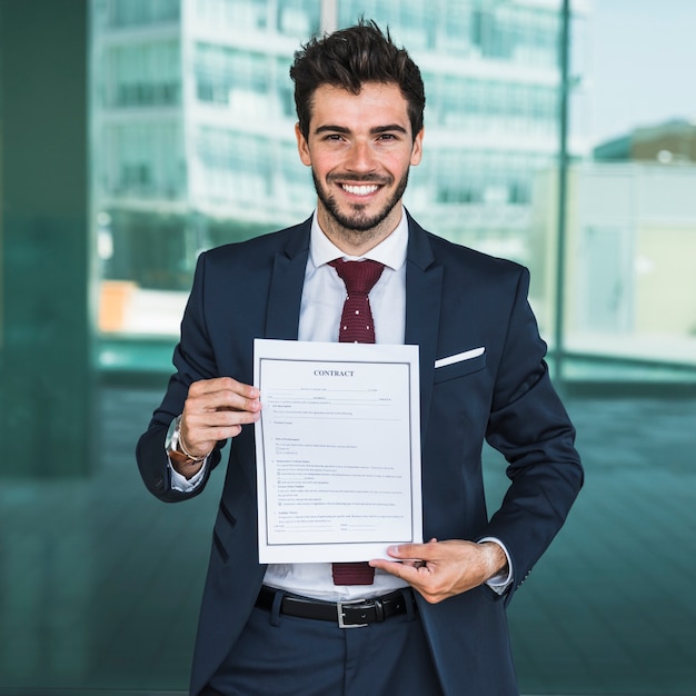 Free photo front view happy man holding a contract