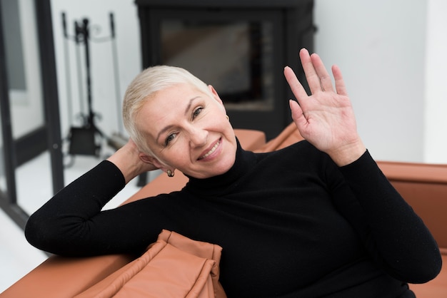 Free photo front view of happy mature woman posing and waving while smiling