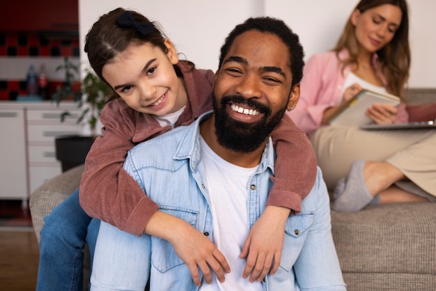 Front view happy parent with kid at home