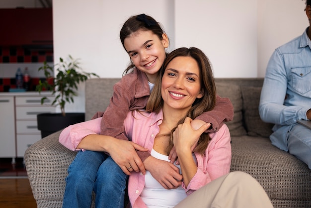 Front view happy parent with kid at home