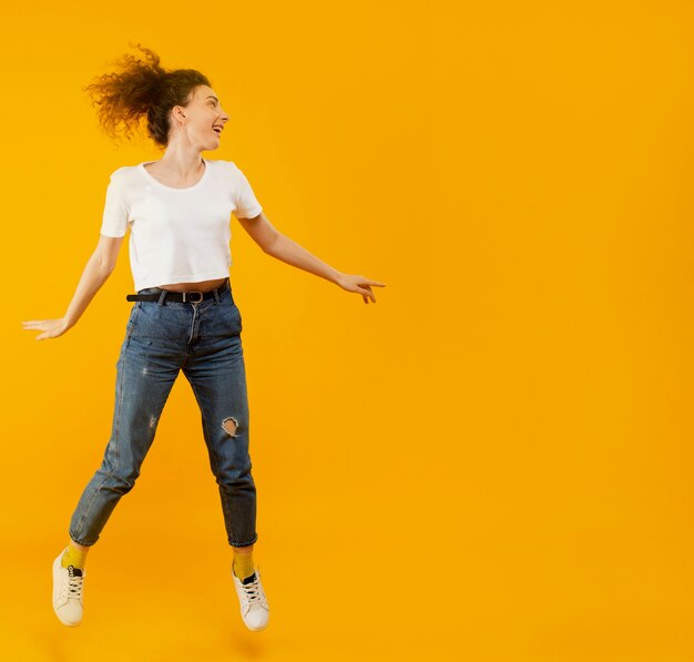 Front view of happy woman jumping