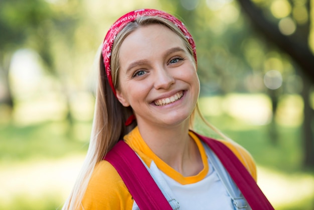 Free photo front view of happy woman posing outdoors