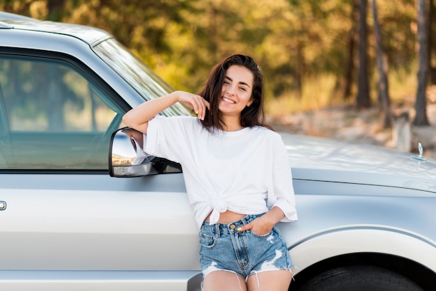 Free photo front view happy woman posing outdoors