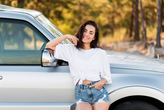 Front view happy woman posing outdoors