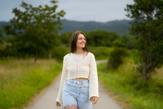 Free photo front view happy woman posing outside