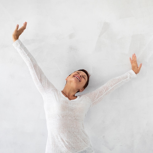 Free photo front view happy woman raising hands