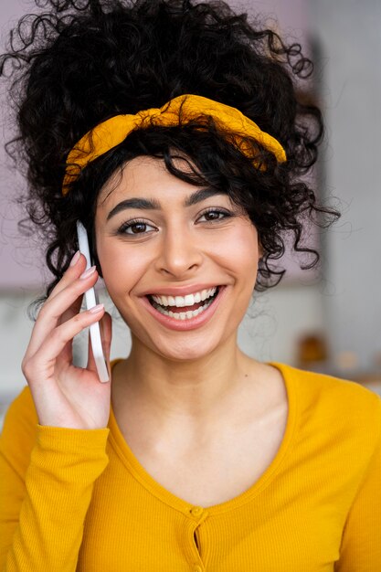 Front view of happy woman smiling and talking on the phone