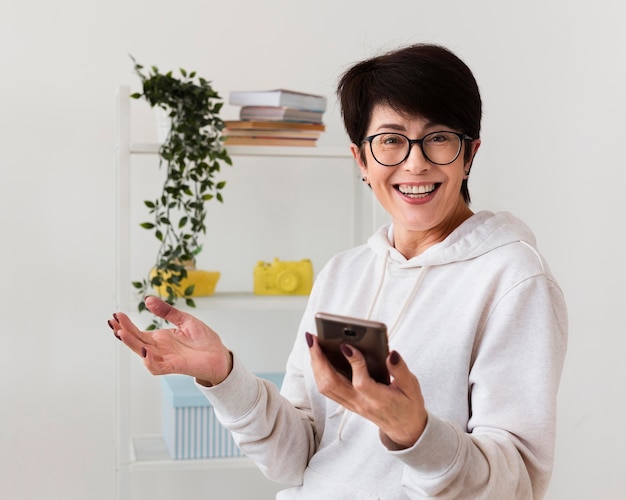 Front view of happy woman with smartphone