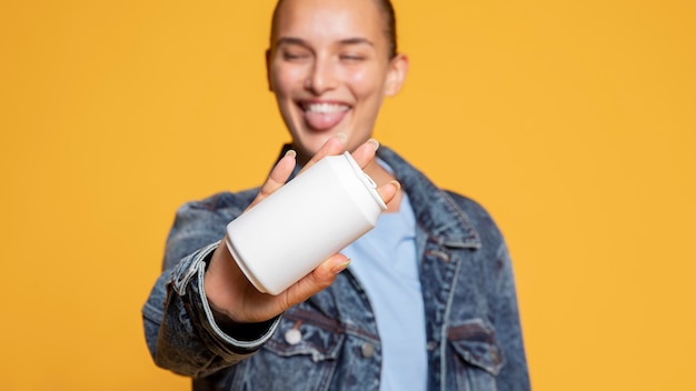 Front view of happy woman with soda can