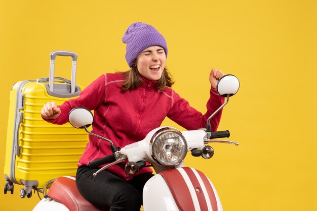 Front view happy young girl on moped