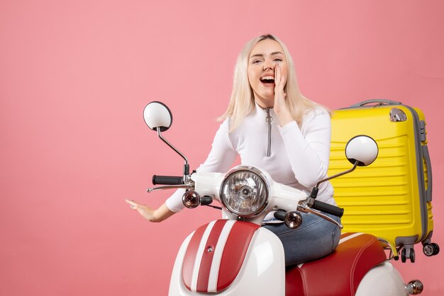 Front view happy young lady on moped shouting