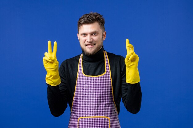 Front view happy young male making victory sign 