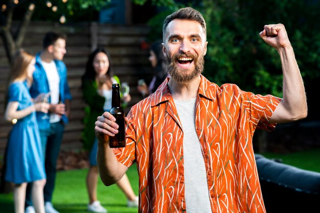 Front view happy young man holding beer