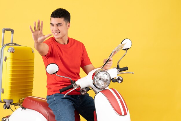 Front view happy young man on moped holding map