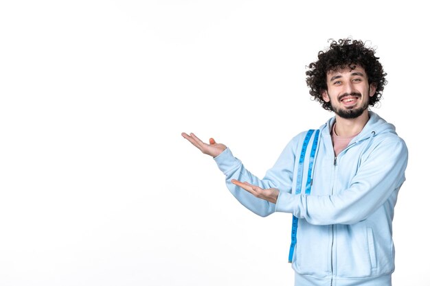 Front view happy young man with measure tape on white background health muscle body waist torso human weight slimming measuring losing