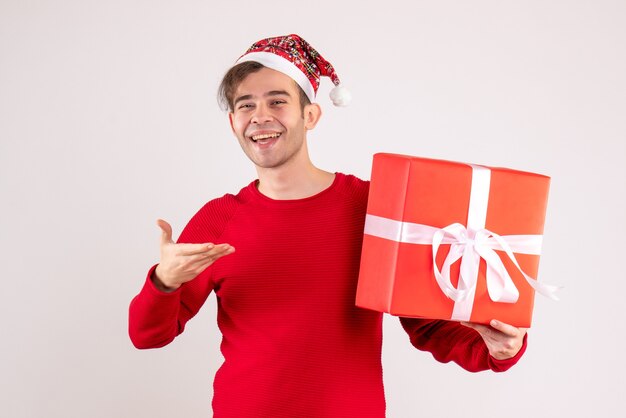 Front view happy young man with santa hat standing on white 