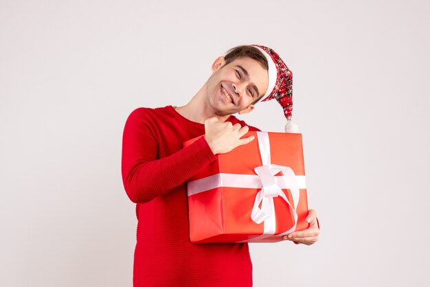 Front view happy young man with santa hat standing on white 