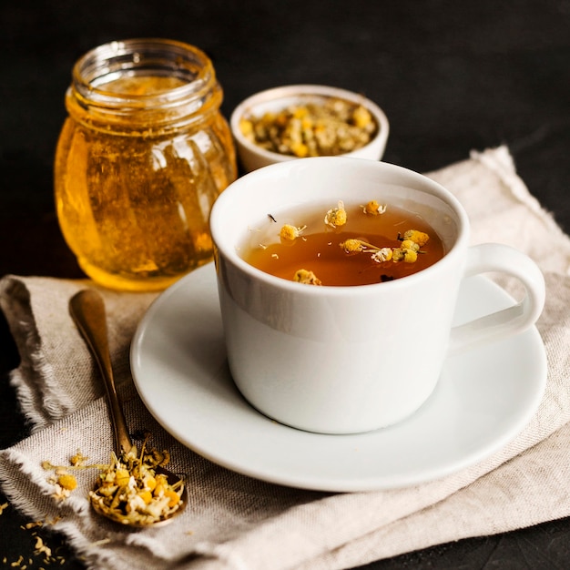 Front view of herbal tea concept with honey
