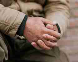 Free photo front view of homeless man hands