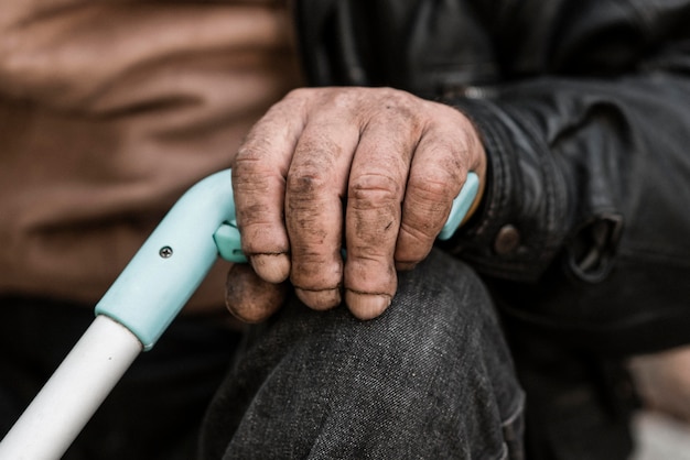 front view of homeless person holding a cane