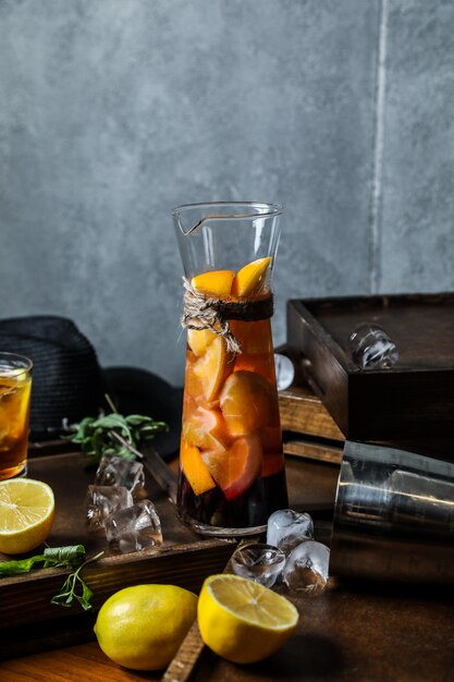 Front view homemade iced tea with lemon in a decanter