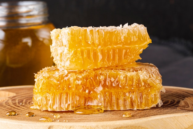 Free photo front view honeycombs on wooden platter