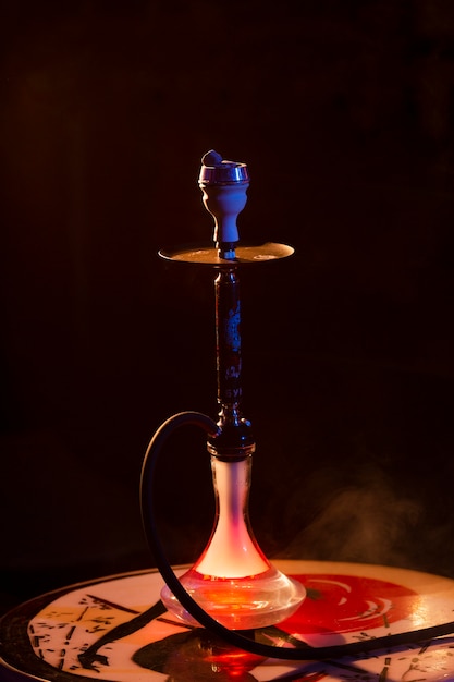 Free photo front view hookah in a bar with fog around