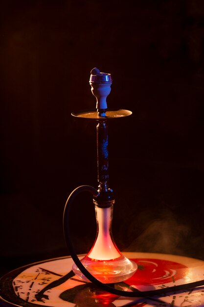 Front view hookah in a bar with fog around