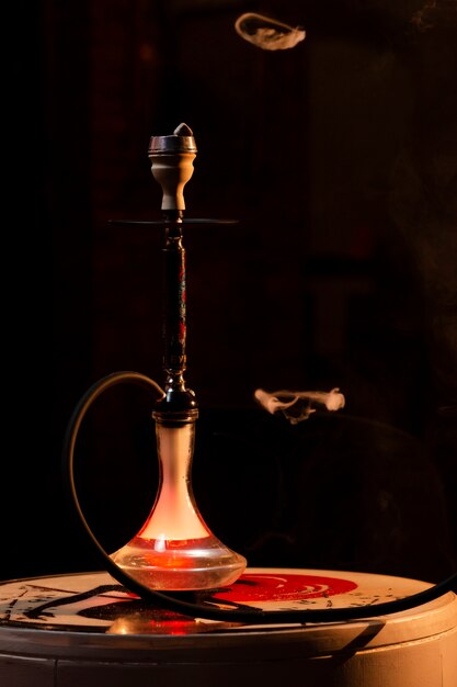 Front view hookah in a bar with fog around