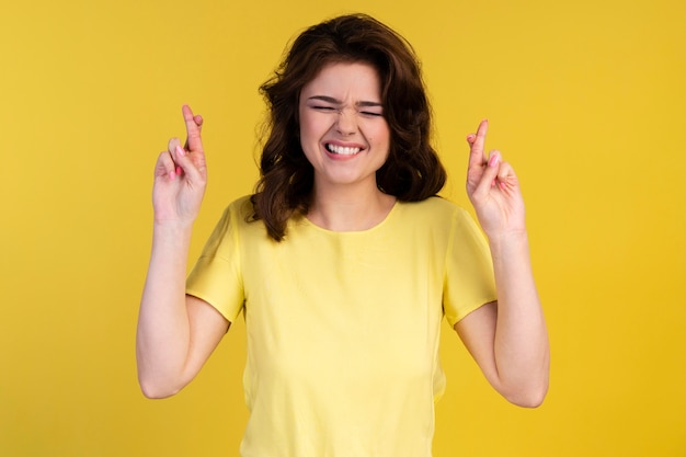 Free photo front view of hopeful woman with fingers crossed