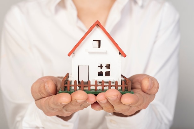 Front view house being hold in hands